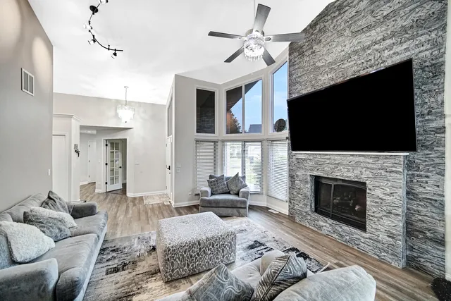 a living room with furniture a fireplace and a flat screen tv
