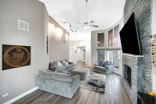 a living room with furniture fireplace and flat screen tv