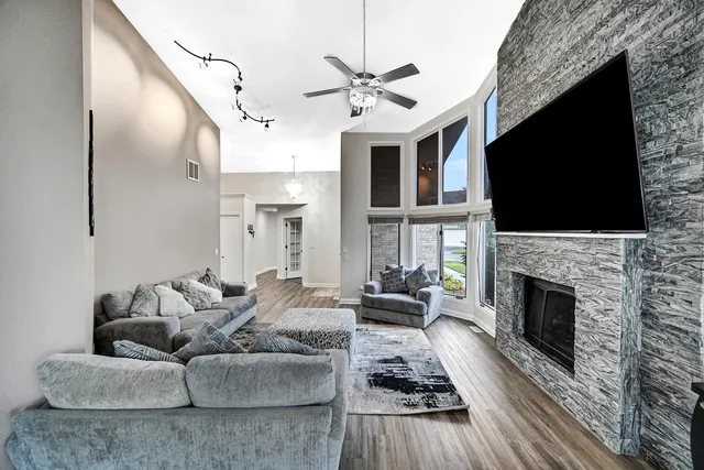 a living room with furniture a flat screen tv and a fireplace