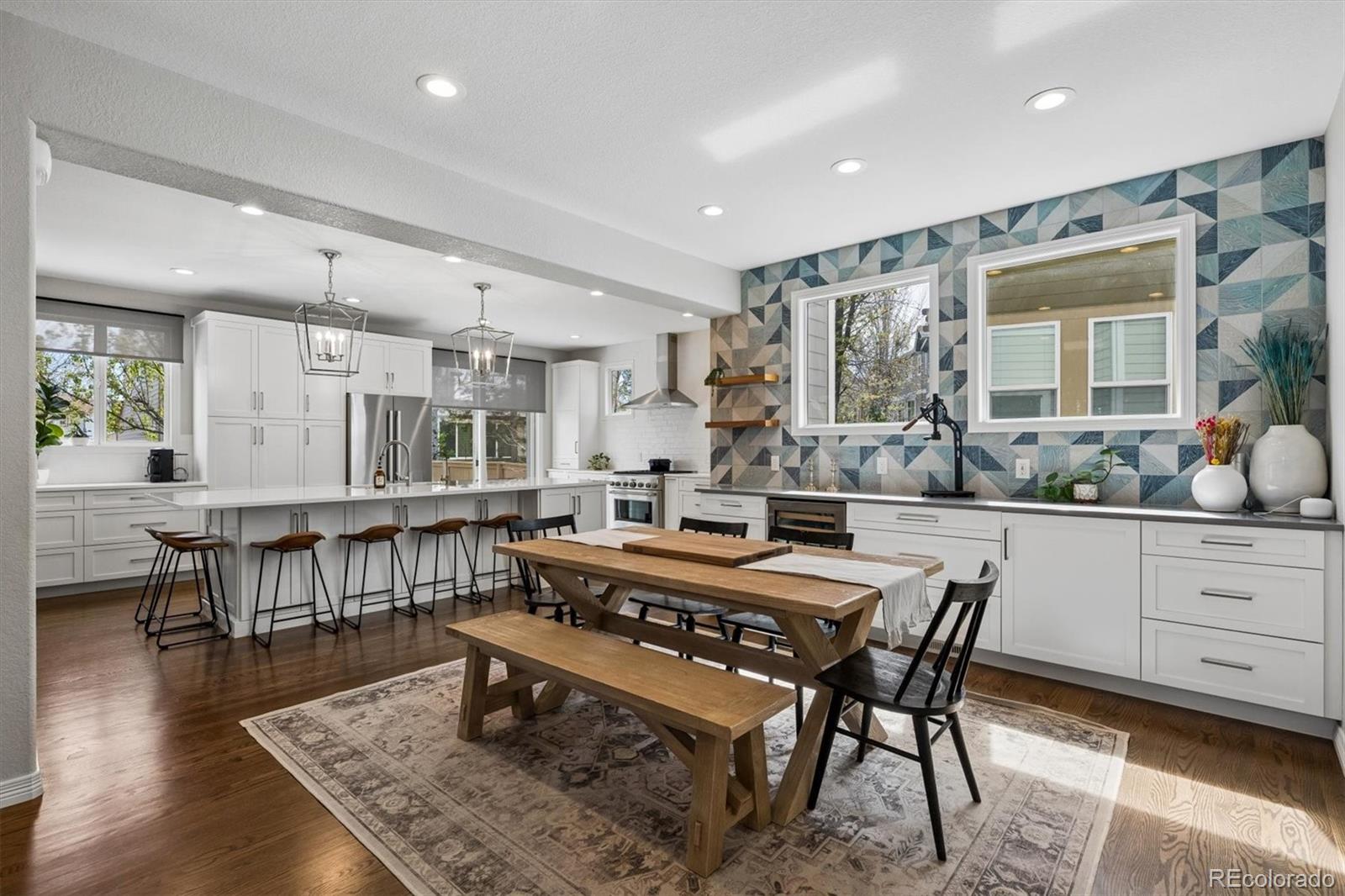 2677 Pemberly Avenue Highlands Ranch, CO 80126 - Photo 11 of 50 a large dining hall with stainless steel appliances granite countertop a stove a sink a dining table and chairs