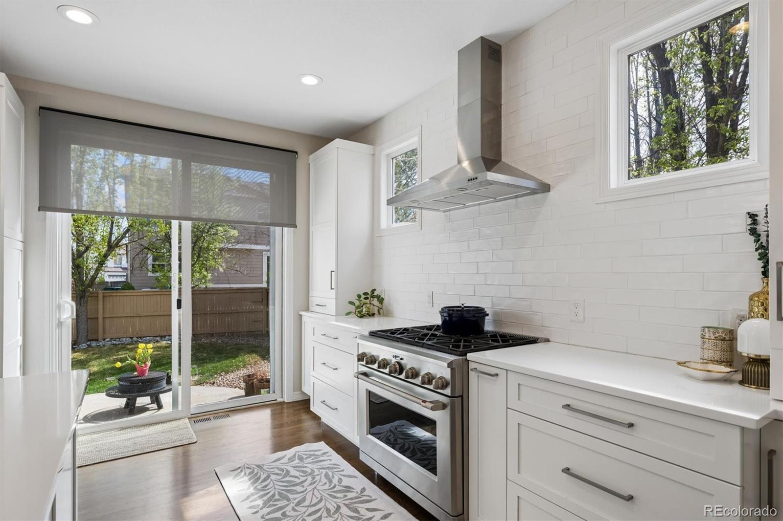 2677 Pemberly Avenue Highlands Ranch, CO 80126 - Photo 13 of 50 a kitchen with stainless steel appliances granite countertop a stove a sink and a refrigerator