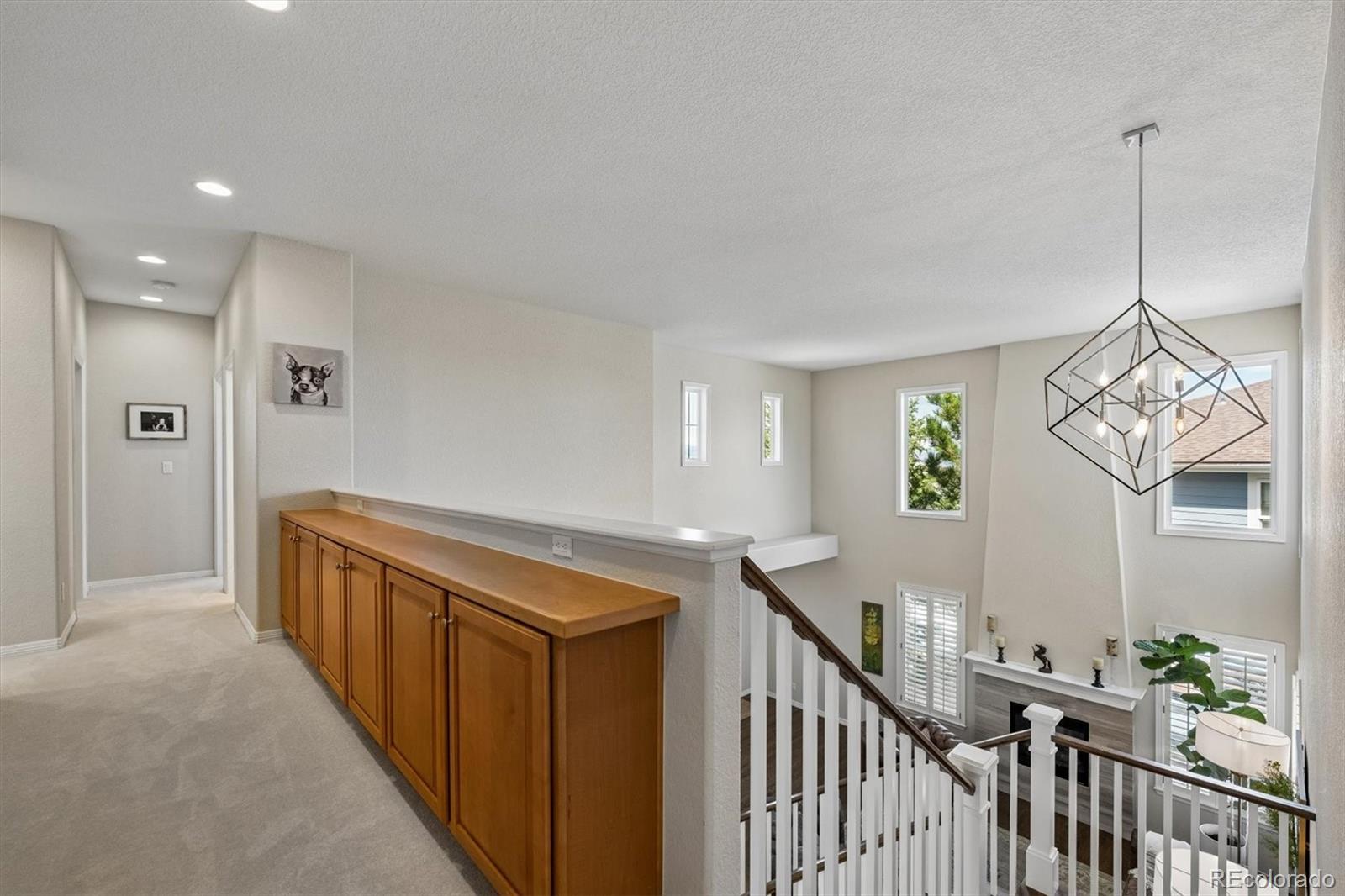 2677 Pemberly Avenue Highlands Ranch, CO 80126 - Photo 24 of 50 a view of a hallway to a livingroom with furniture and stairs