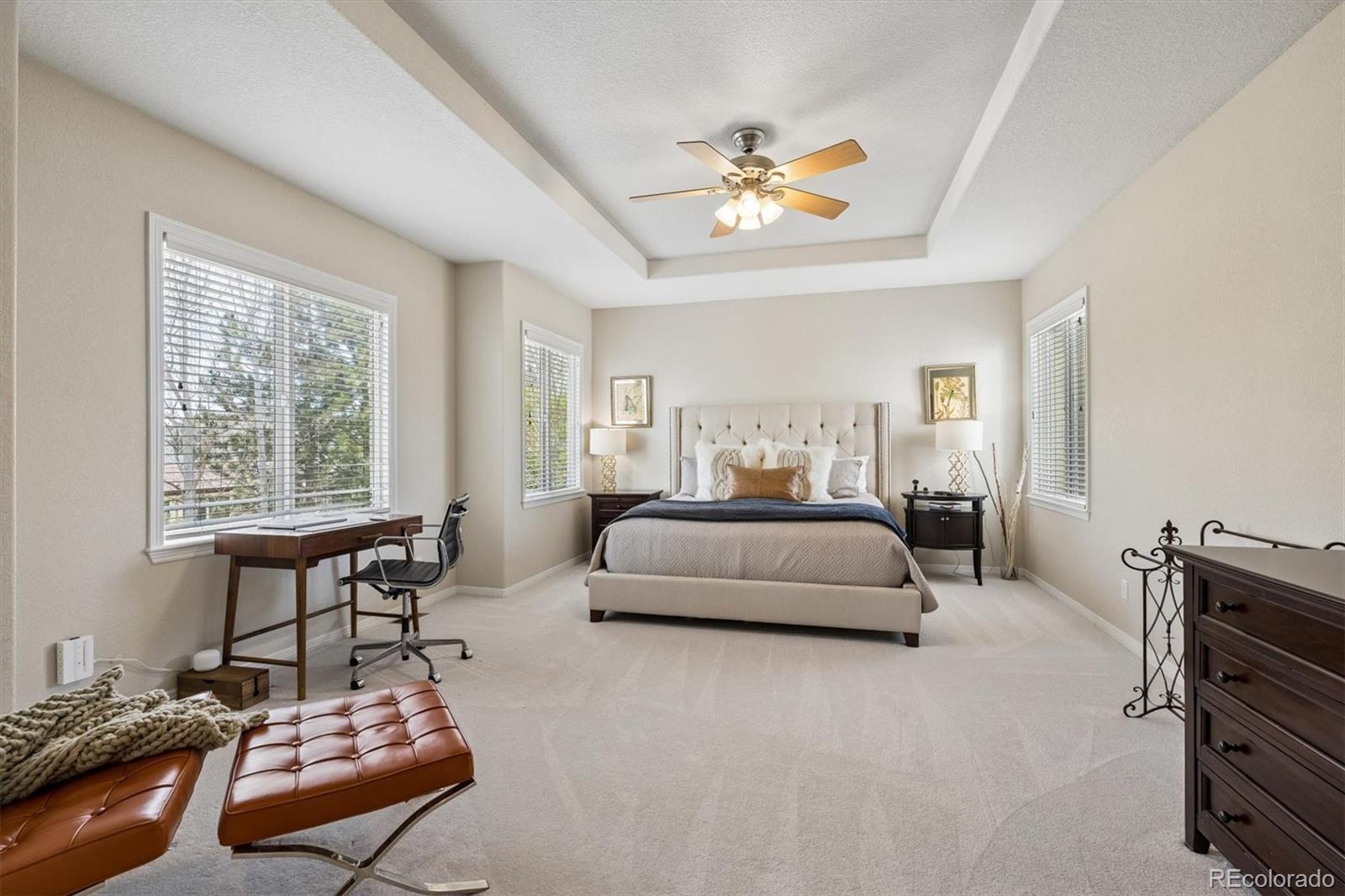 2677 Pemberly Avenue Highlands Ranch, CO 80126 - Photo 25 of 50 a bedroom with a bed and a chandelier