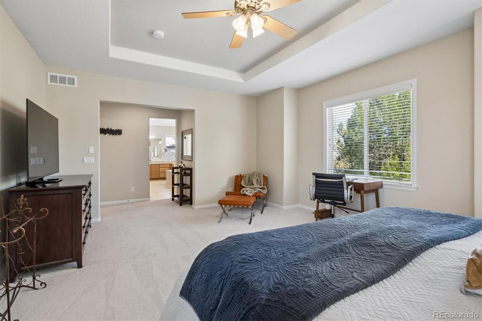 2677 Pemberly Avenue Highlands Ranch, CO 80126 - Photo 26 of 50 a bedroom with furniture and a flat screen tv