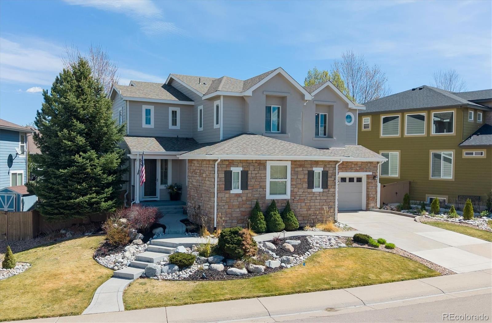 2677 Pemberly Avenue Highlands Ranch, CO 80126 - Photo 3 of 50 a front view of a house with garden