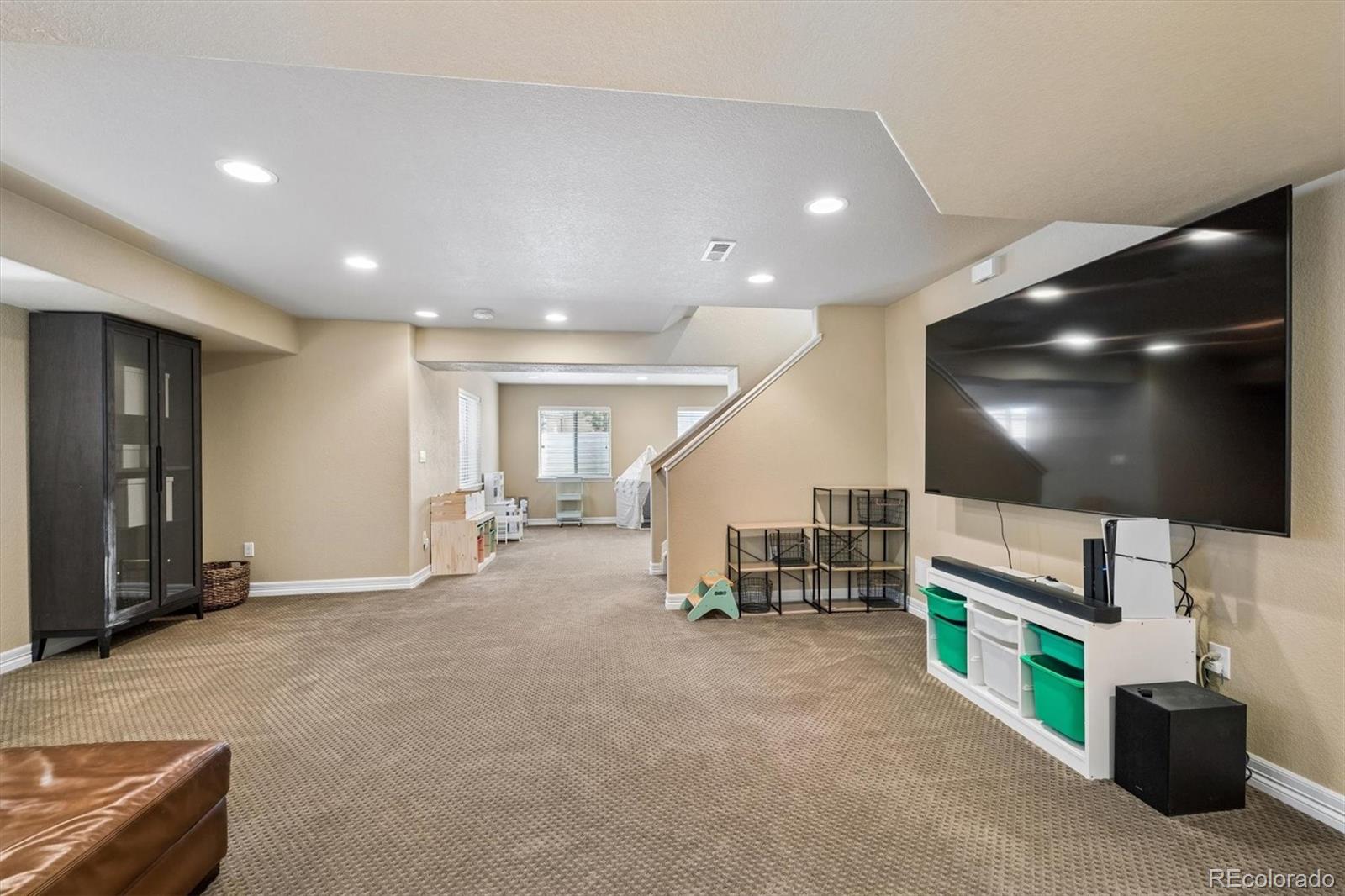 2677 Pemberly Avenue Highlands Ranch, CO 80126 - Photo 35 of 50 a living room with furniture and a flat screen tv