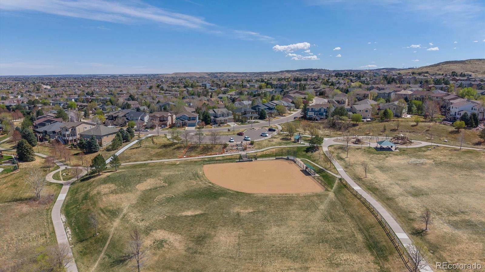 2677 Pemberly Avenue Highlands Ranch, CO 80126 - Photo 47 of 50 a view of a swimming pool and a lot of car parked