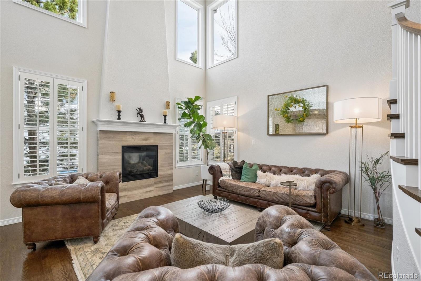 2677 Pemberly Avenue Highlands Ranch, CO 80126 - Photo 7 of 50 a living room with furniture and a fireplace