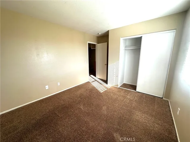 a view of an empty room and closet area