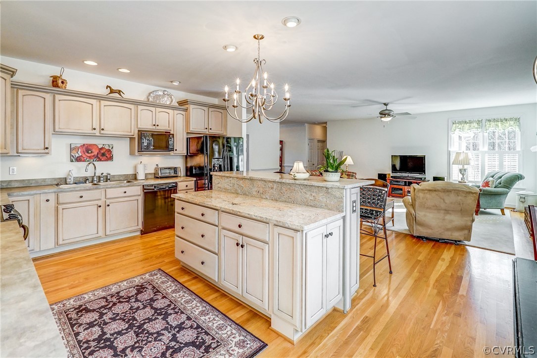 3982 County Line Road Kents Store, VA 23084 - Photo 4 of 49 a kitchen with stainless steel appliances kitchen island granite countertop a stove top oven a sink dishwasher and white cabinets with wooden floor