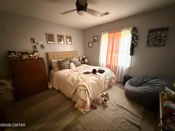 a view of a hallway view with wooden floor and staircase