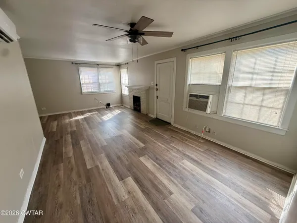 wooden floor in an empty room with a window