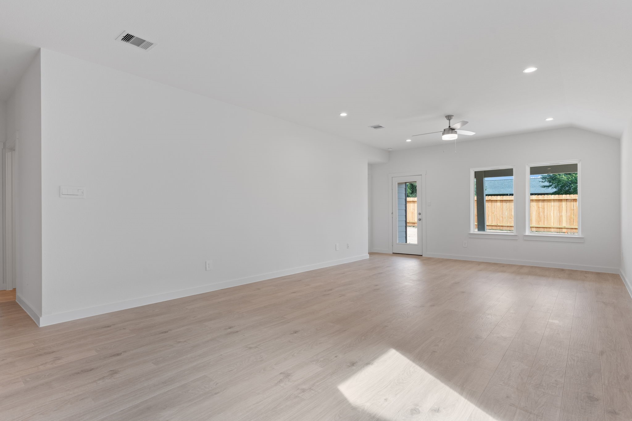 1603 Cinque Terre Way Richmond, TX 77406 - Photo 18 of 31 an empty room with wooden floor and windows