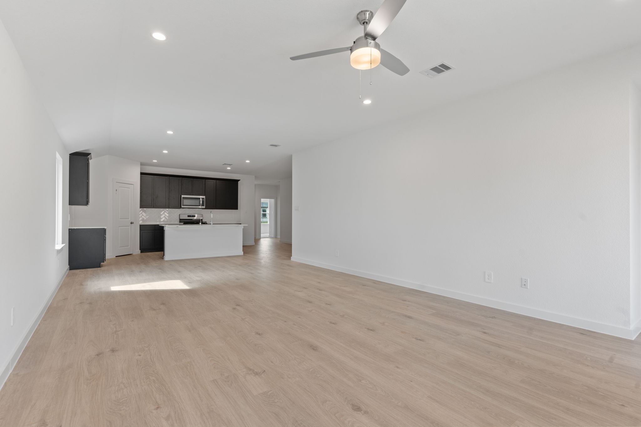1603 Cinque Terre Way Richmond, TX 77406 - Photo 19 of 31 a view of a kitchen with a sink and a stove top oven