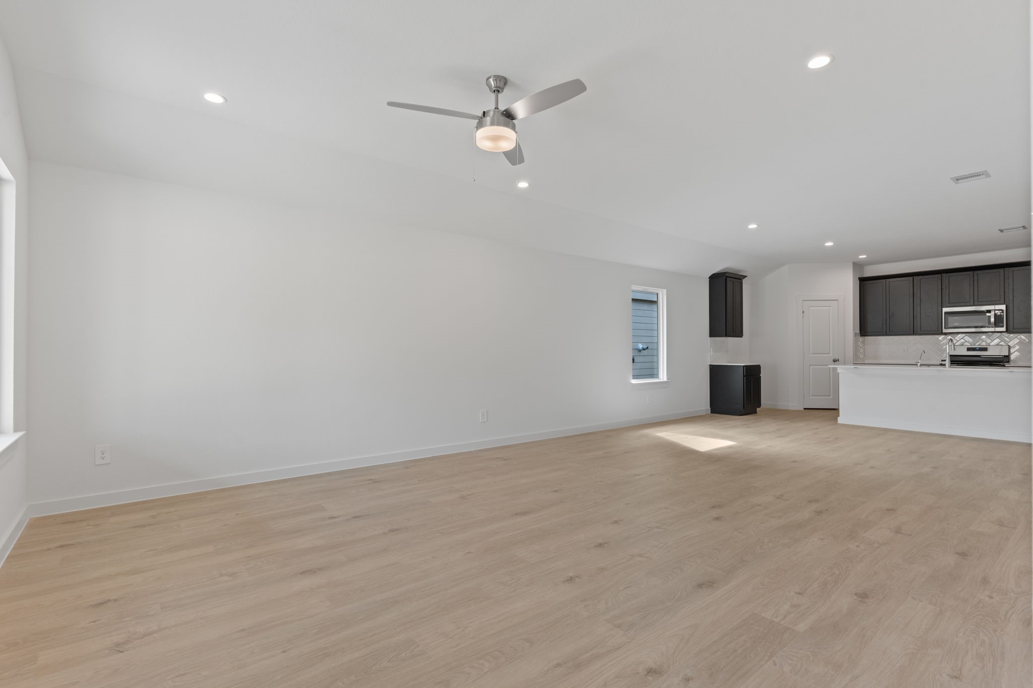 1603 Cinque Terre Way Richmond, TX 77406 - Photo 20 of 31 a view of a kitchen with a sink and a stove top oven