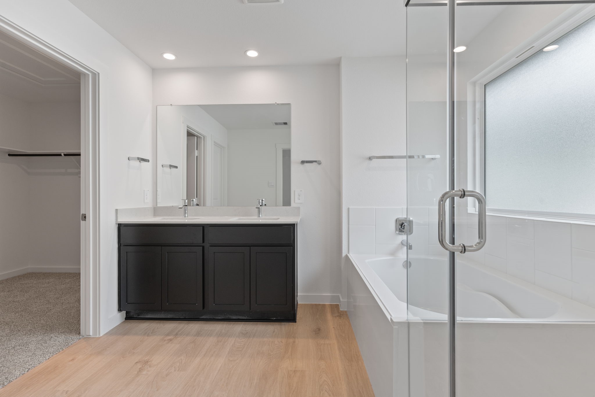 1603 Cinque Terre Way Richmond, TX 77406 - Photo 24 of 31 a bathroom with a double vanity sink a mirror and shower