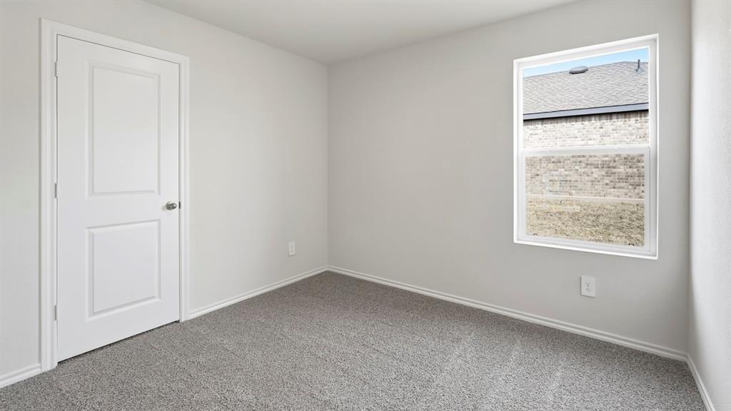3535 Spring Time Street Forney, TX 75126 - Photo 18 of 23 Neutral-toned room featuring light gray walls and a single white-framed window