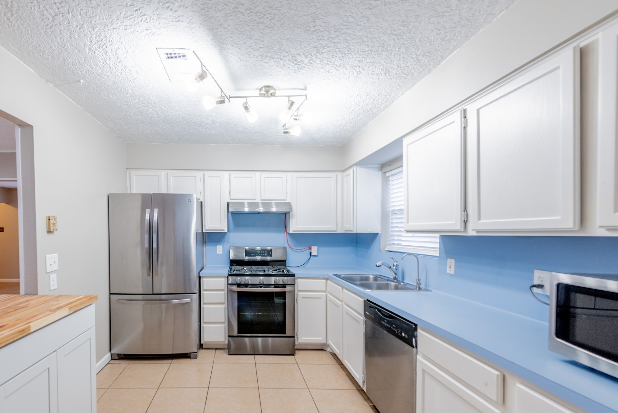 10823 Overlea Drive Houston, TX 77089 - Photo 12 of 36 a kitchen with stainless steel appliances a refrigerator sink and cabinets