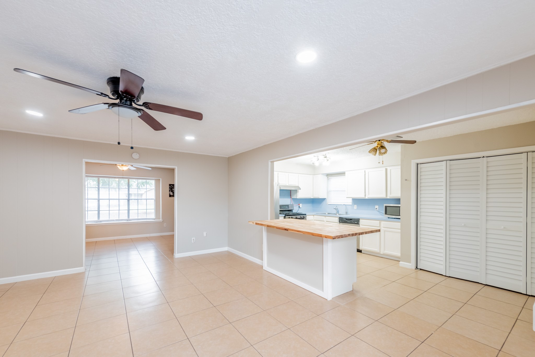 10823 Overlea Drive Houston, TX 77089 - Photo 13 of 36 a kitchen with a stove a sink and a refrigerator