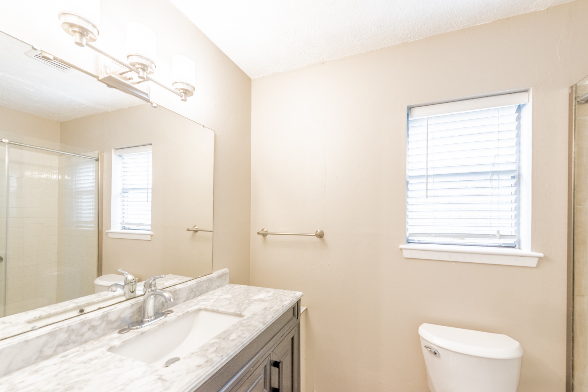 10823 Overlea Drive Houston, TX 77089 - Photo 17 of 36 a bathroom with a granite countertop sink mirror and a toilet