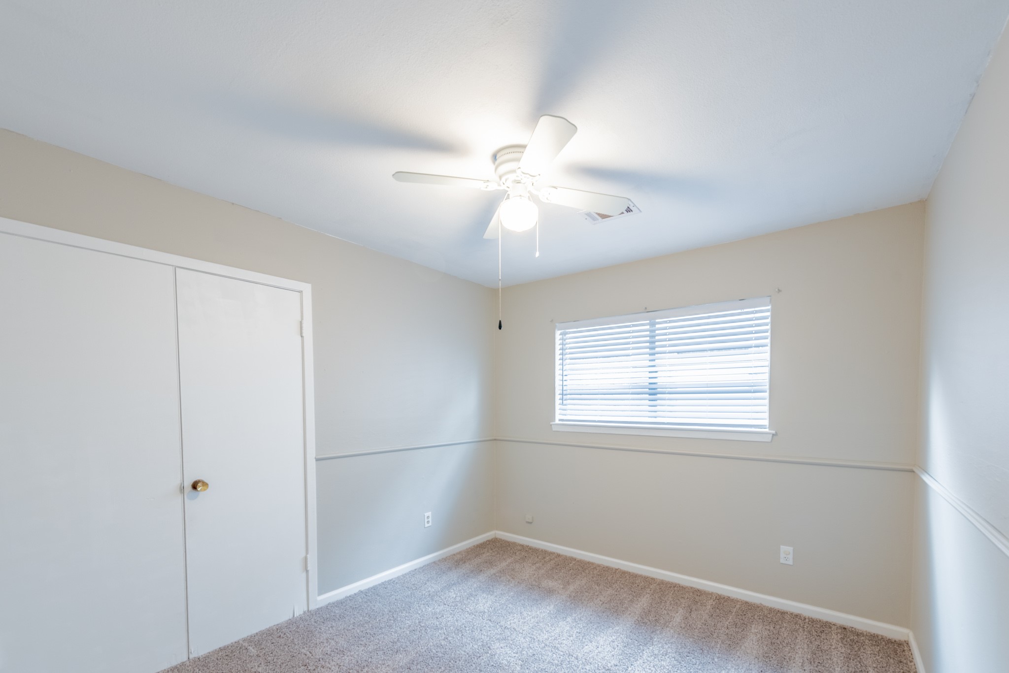 10823 Overlea Drive Houston, TX 77089 - Photo 18 of 36 an empty room with windows and fan