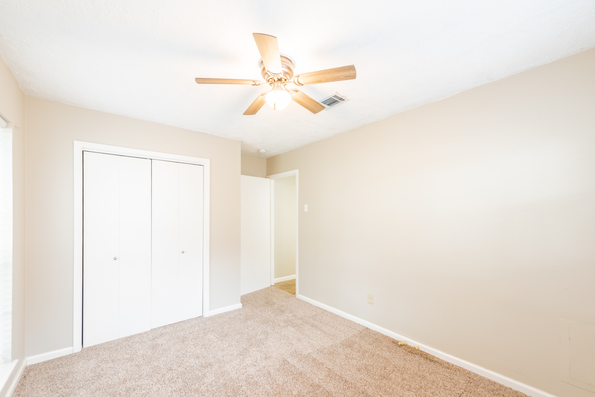 10823 Overlea Drive Houston, TX 77089 - Photo 23 of 36 a view of a room with a ceiling fan and a window