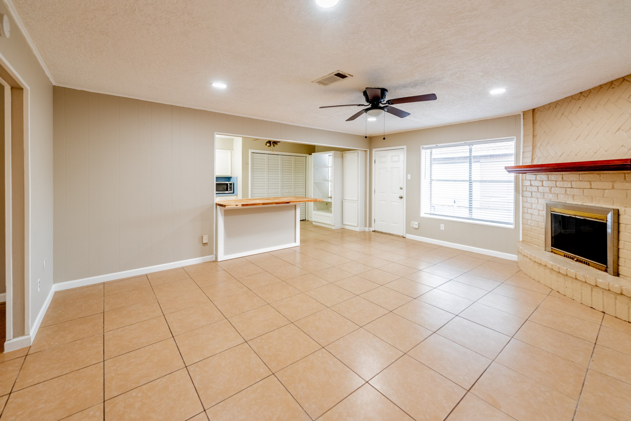 10823 Overlea Drive Houston, TX 77089 - Photo 9 of 36 a view of an empty room with a fireplace and a window