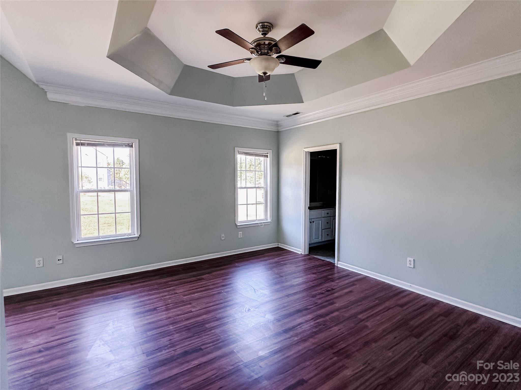 181 Weathers Creek Road Troutman, NC 28166 - Photo 12 of 25 a view of an empty room with wooden floor and a window