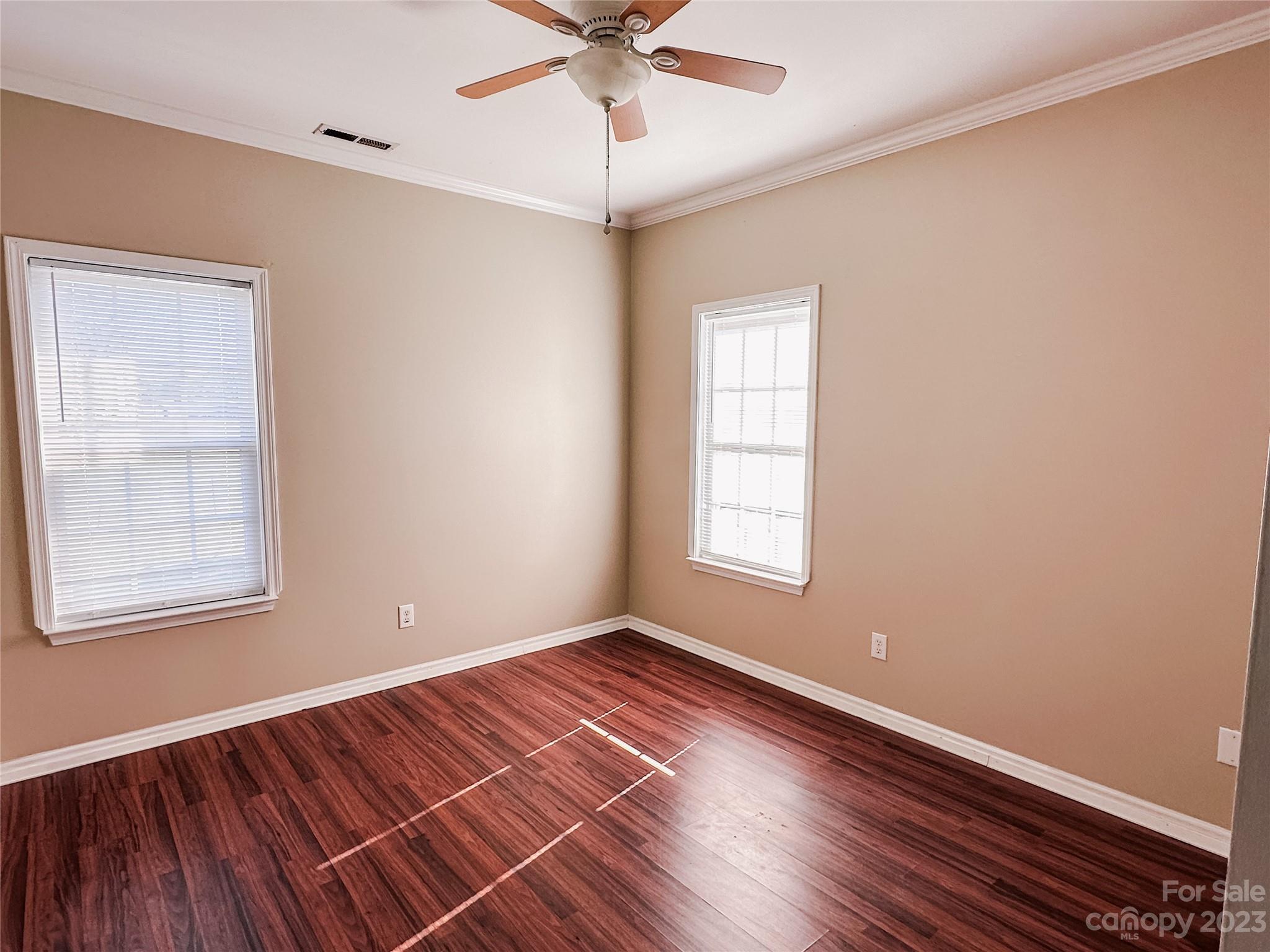 181 Weathers Creek Road Troutman, NC 28166 - Photo 16 of 25 a view of an empty room with wooden floor and a window
