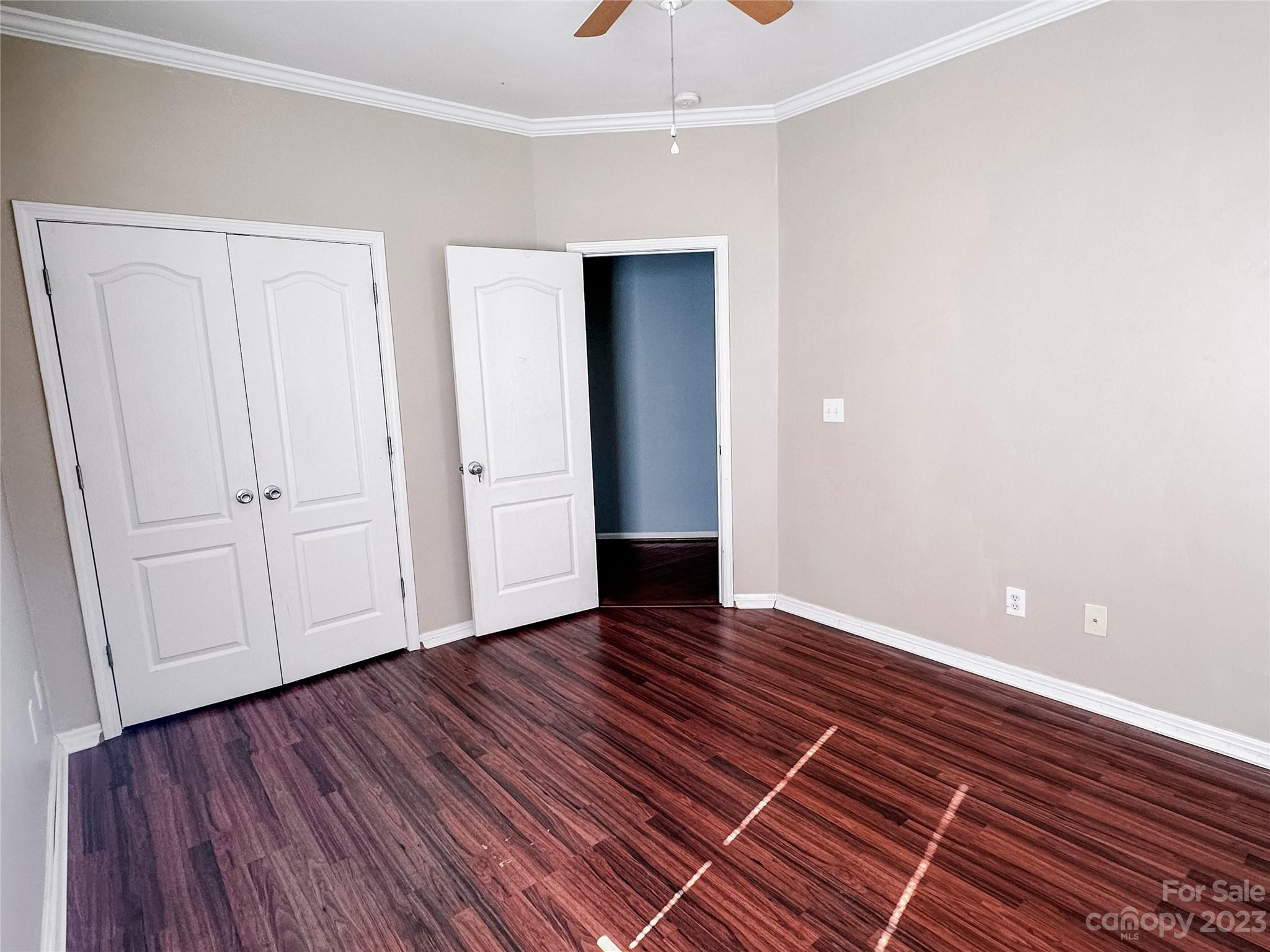 181 Weathers Creek Road Troutman, NC 28166 - Photo 17 of 25 a view of an empty room with wooden floor and a window