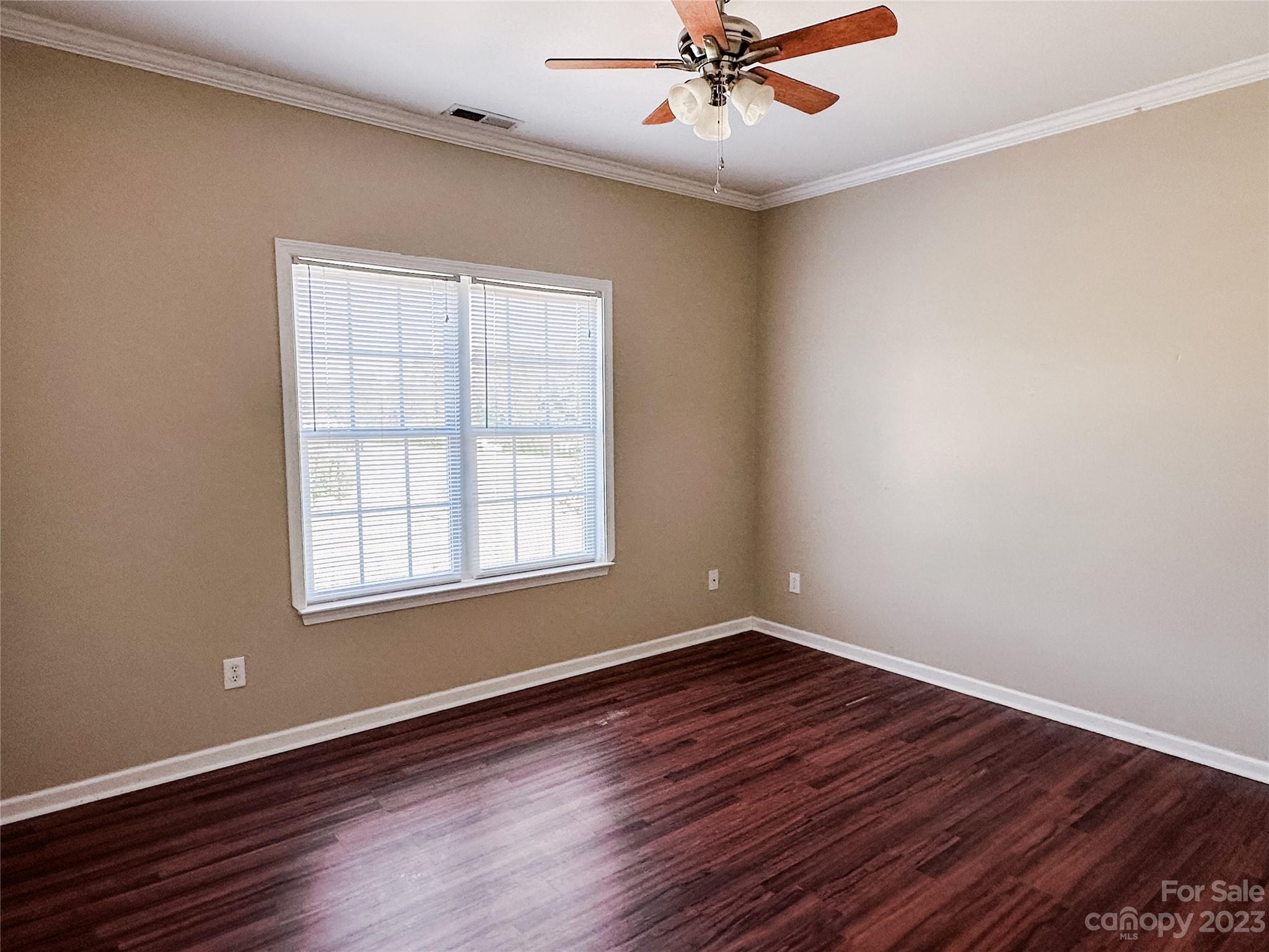 181 Weathers Creek Road Troutman, NC 28166 - Photo 19 of 25 a view of an empty room with wooden floor and a window