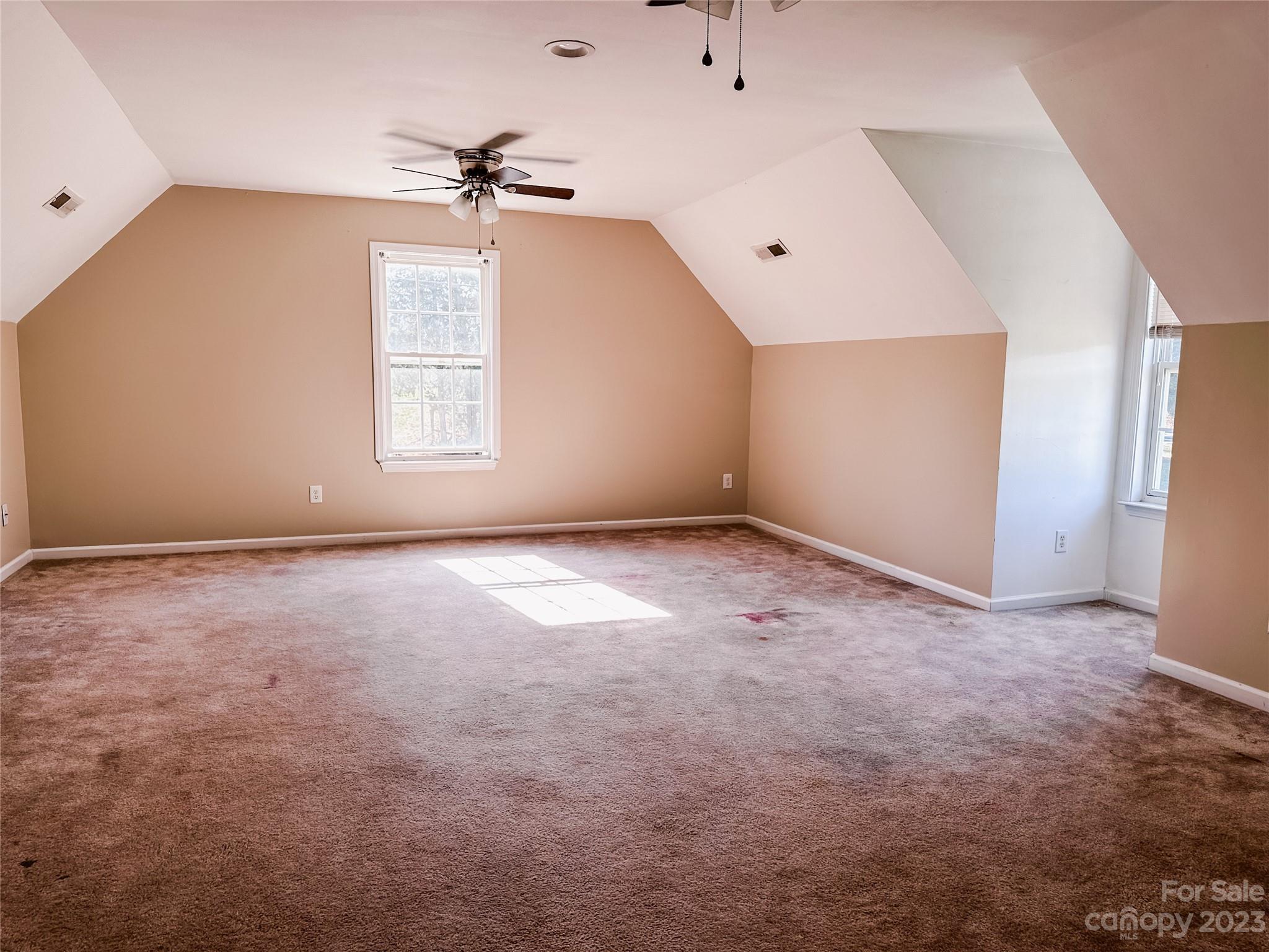 181 Weathers Creek Road Troutman, NC 28166 - Photo 21 of 25 an empty room with a ceiling fan and window