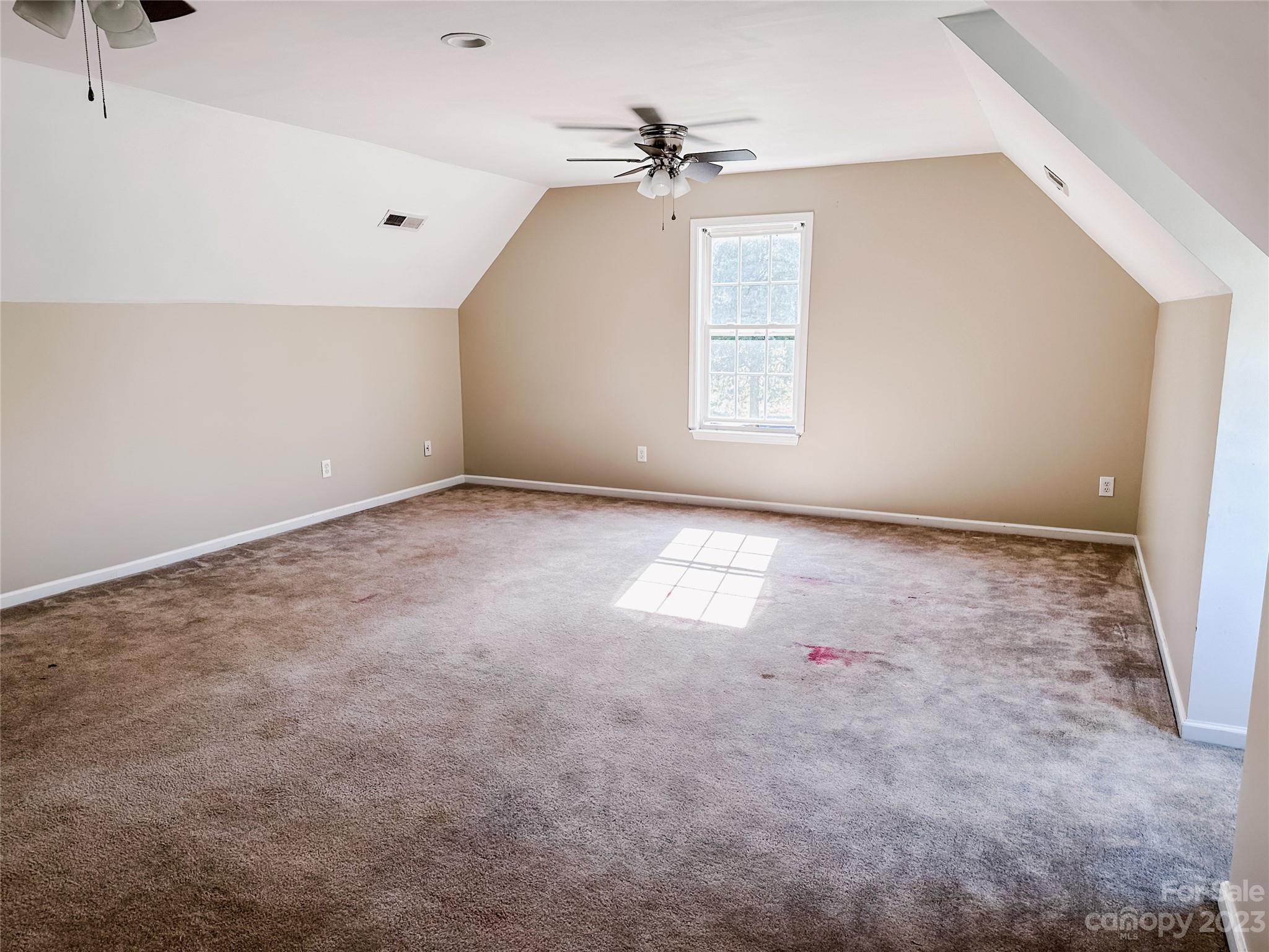 181 Weathers Creek Road Troutman, NC 28166 - Photo 22 of 25 an empty room with windows and fan
