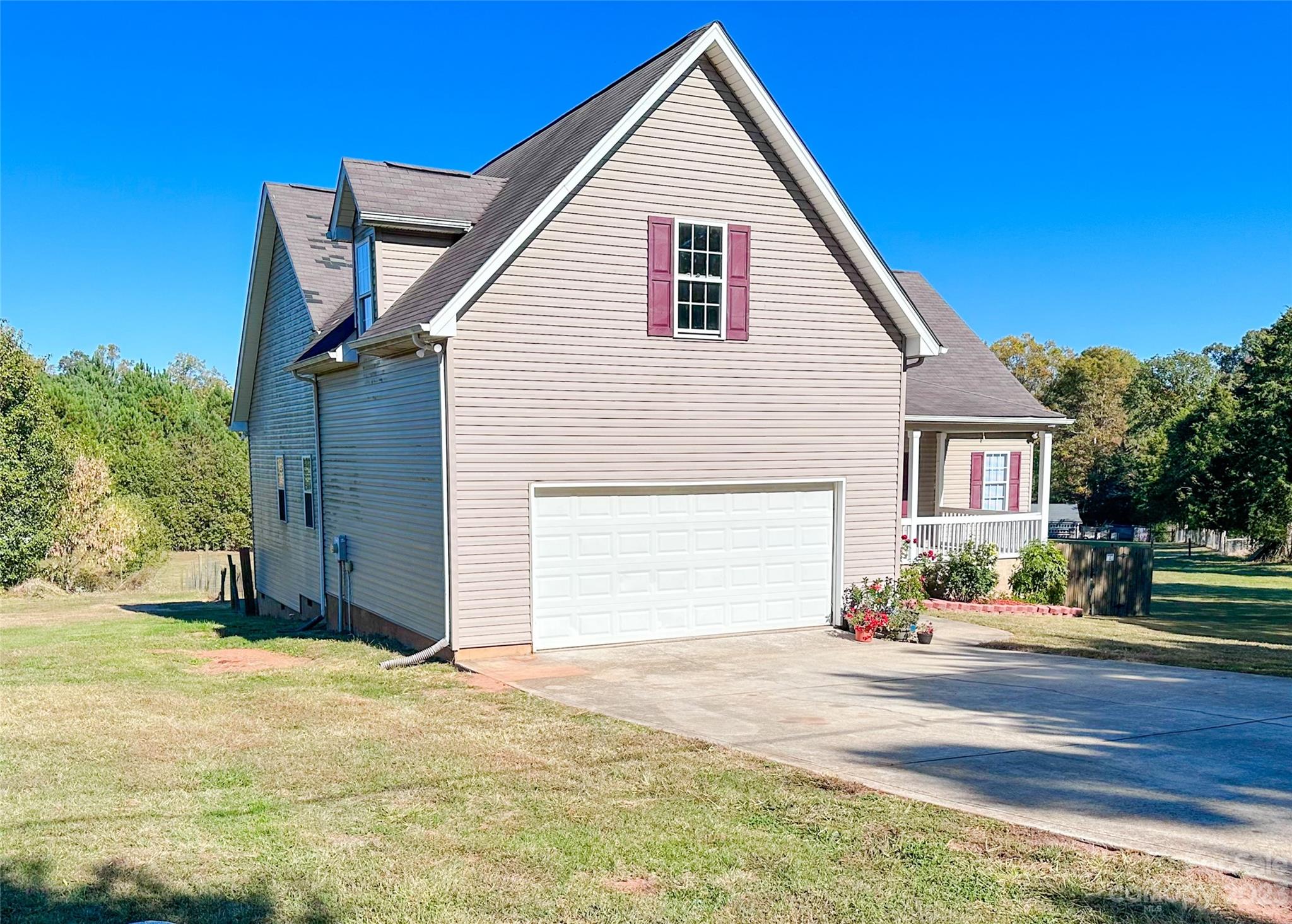 181 Weathers Creek Road Troutman, NC 28166 - Photo 4 of 25 a view of an house with backyard and trees