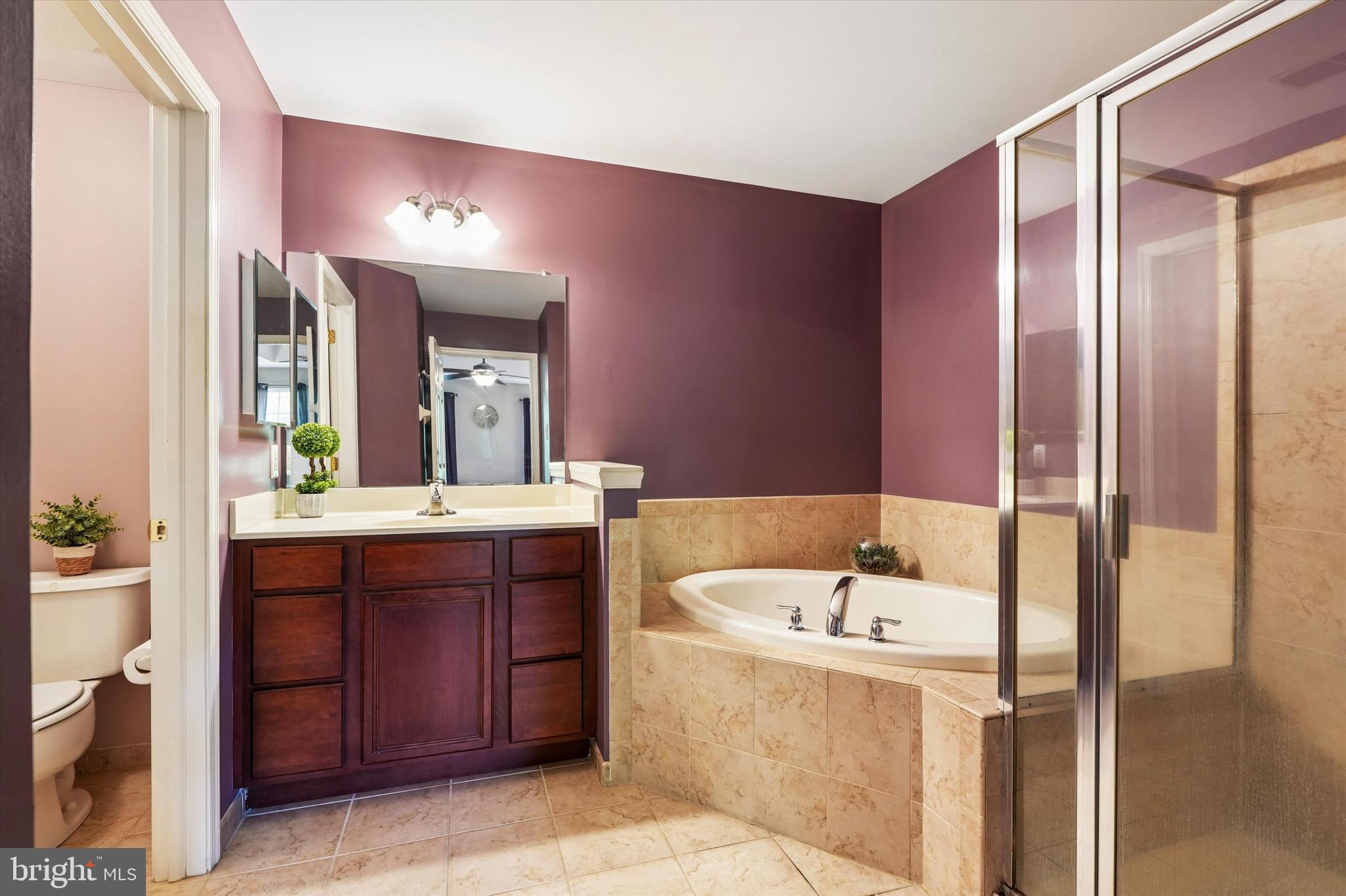 215 Flagstone Road, Unit 1 Chester Springs, PA 19425 - Photo 22 of 33 a bathroom with a tub a sink and mirror