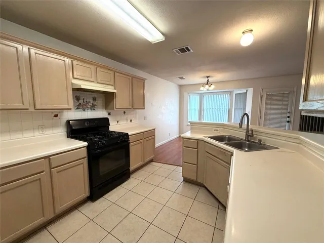 a kitchen with stainless steel appliances granite countertop a sink and cabinets