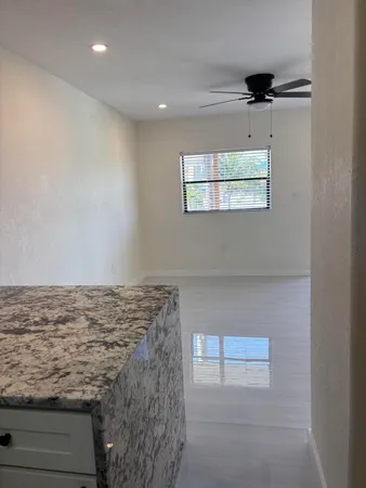 a view of kitchen with refrigerator and microwave