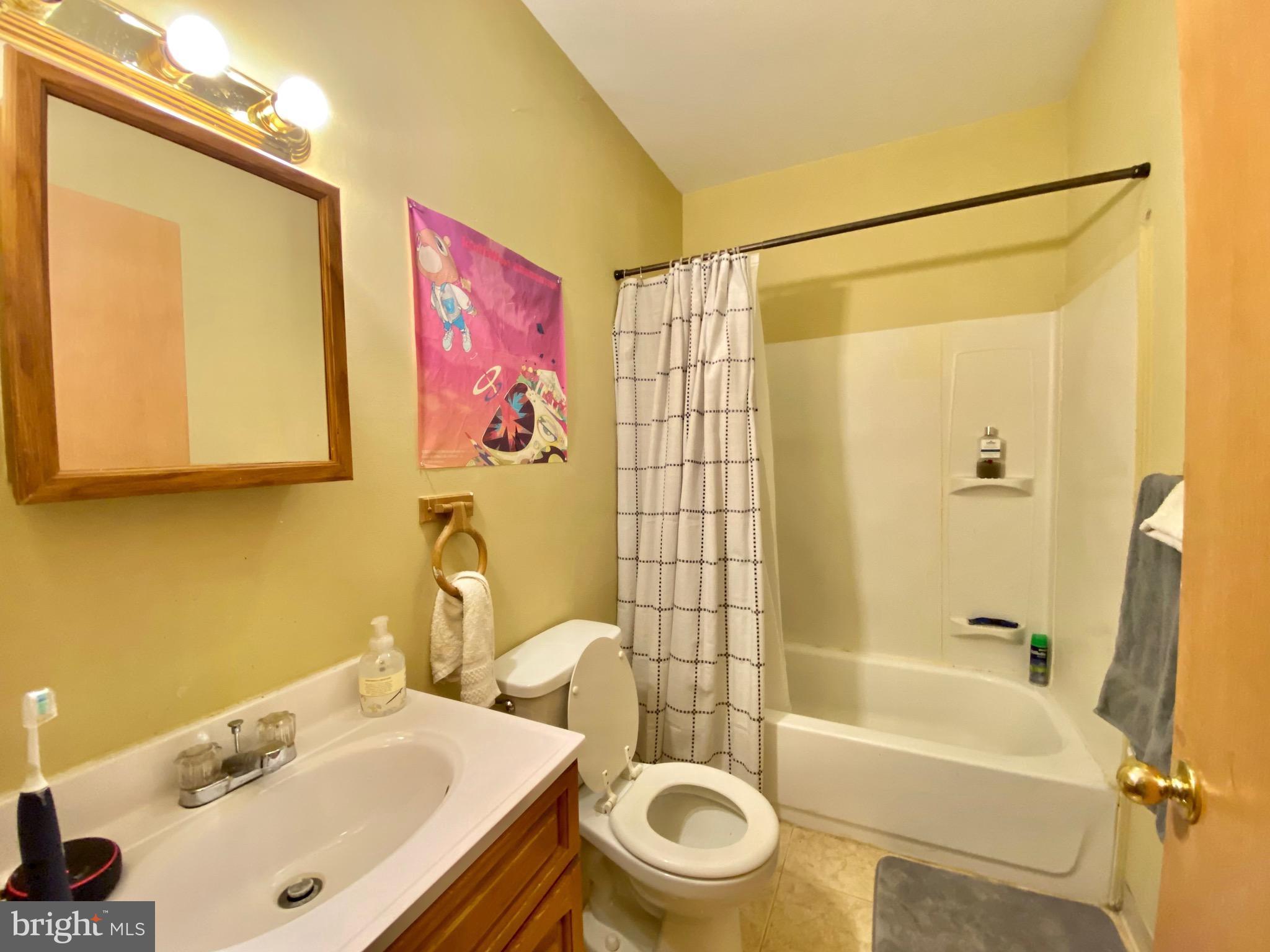 1435 West Norris Street, Unit B Philadelphia, PA 19121 - Photo 14 of 24 a bathroom with a sink mirror toilet and bathtub