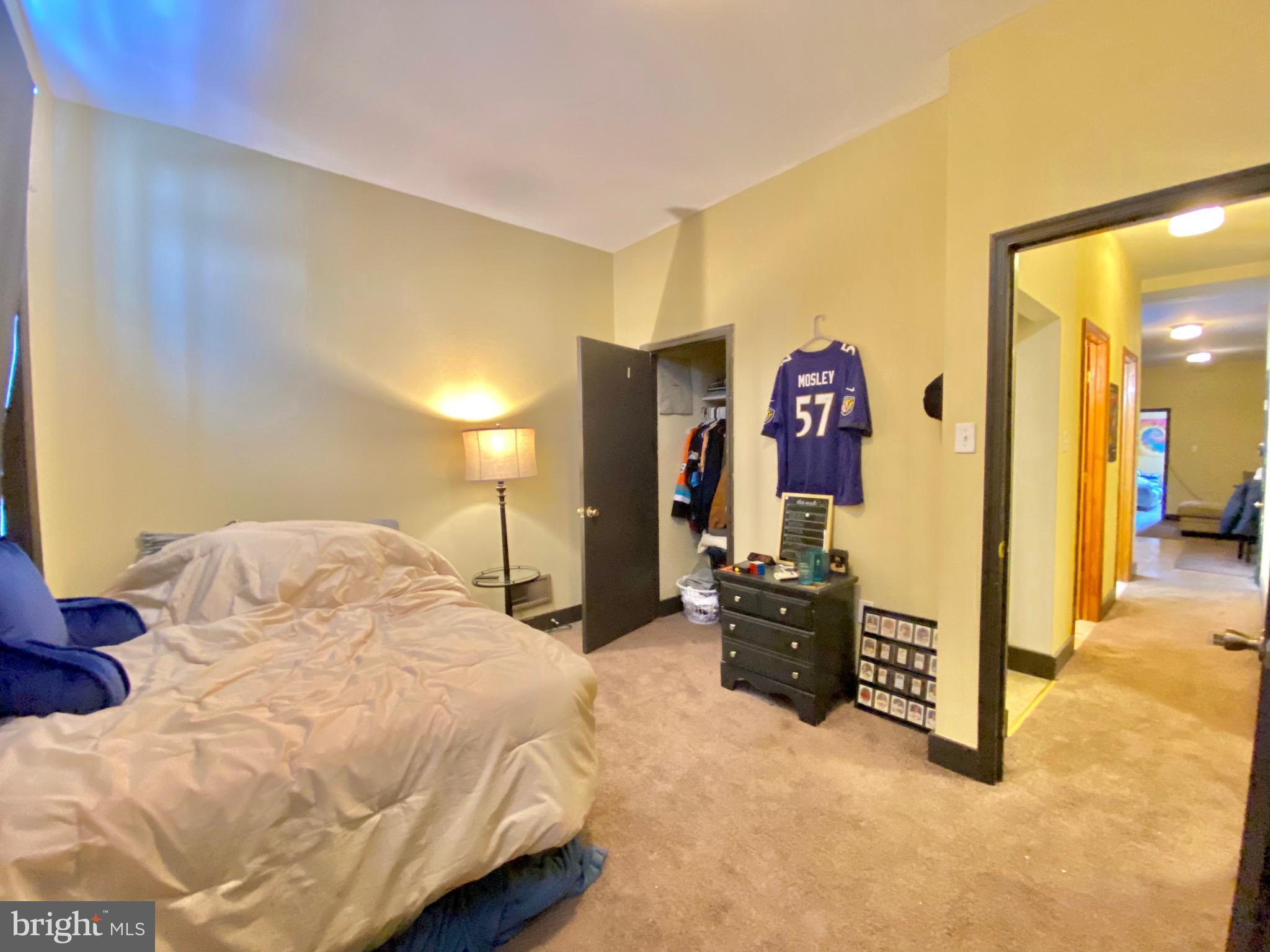 1435 West Norris Street, Unit B Philadelphia, PA 19121 - Photo 17 of 24 a bedroom with a bed and dresser with mirror