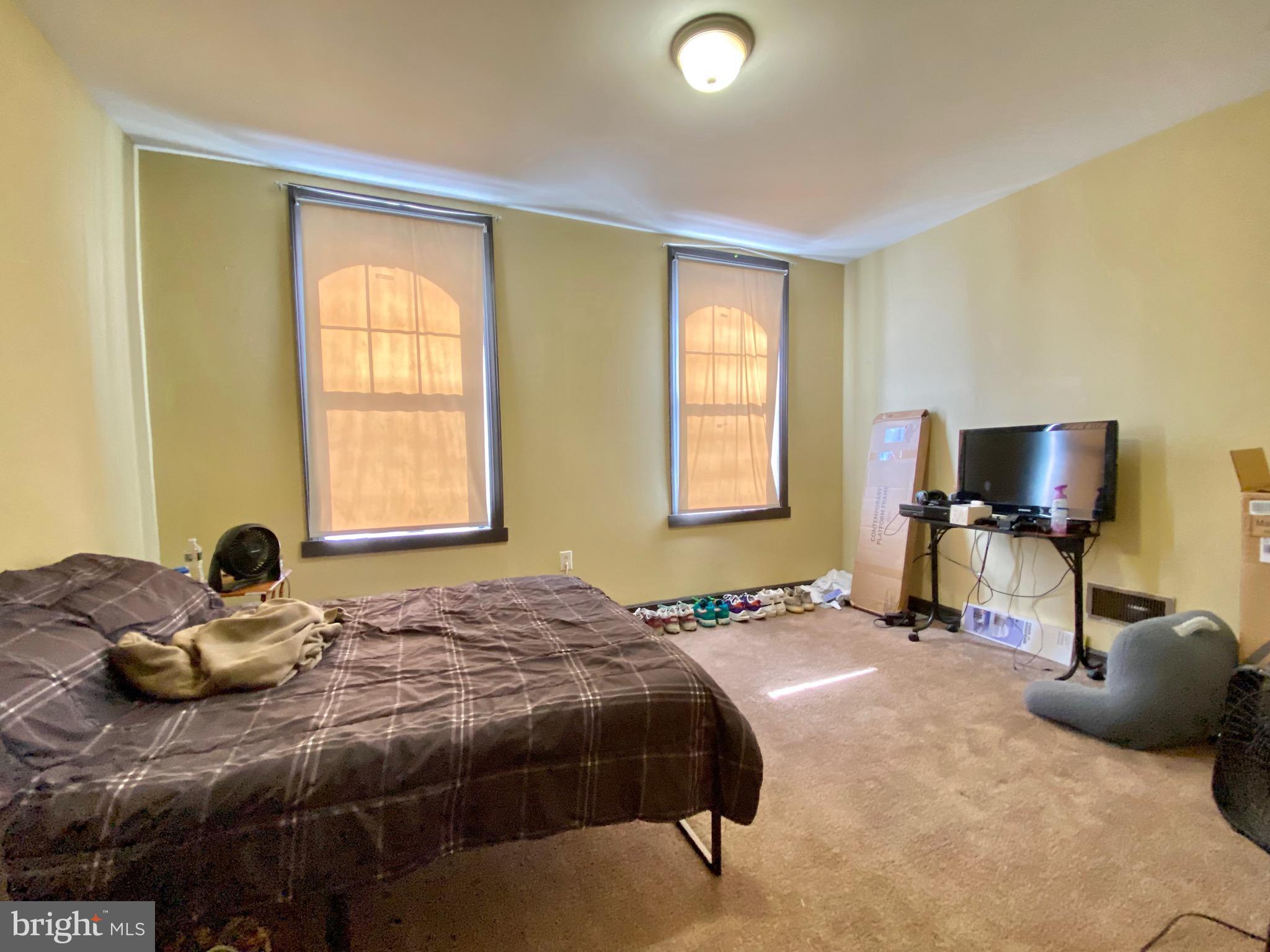 1435 West Norris Street, Unit B Philadelphia, PA 19121 - Photo 24 of 24 a bedroom with a bed and a flat screen tv
