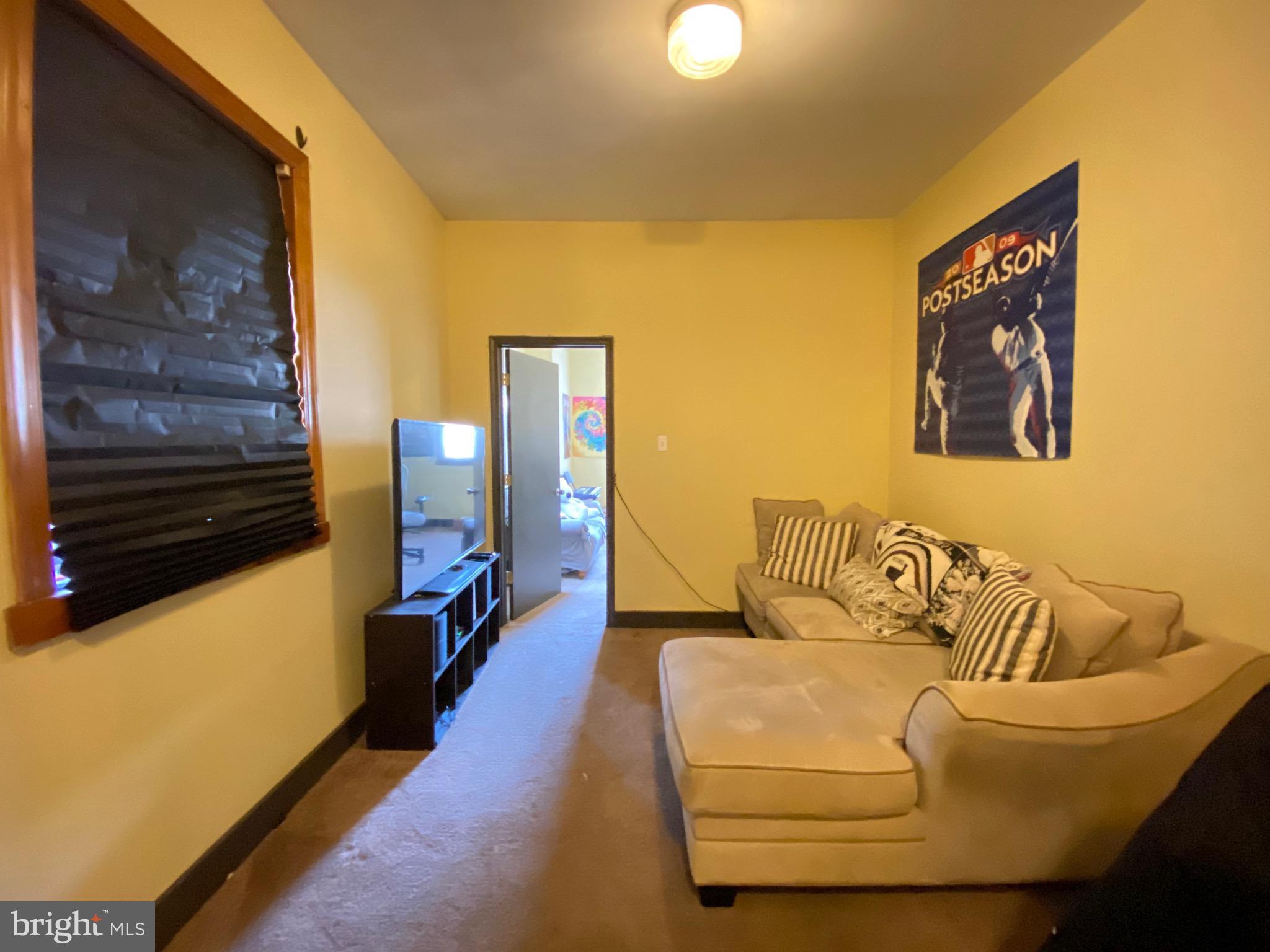 1435 West Norris Street, Unit B Philadelphia, PA 19121 - Photo 6 of 24 a living room with furniture and a flat screen tv