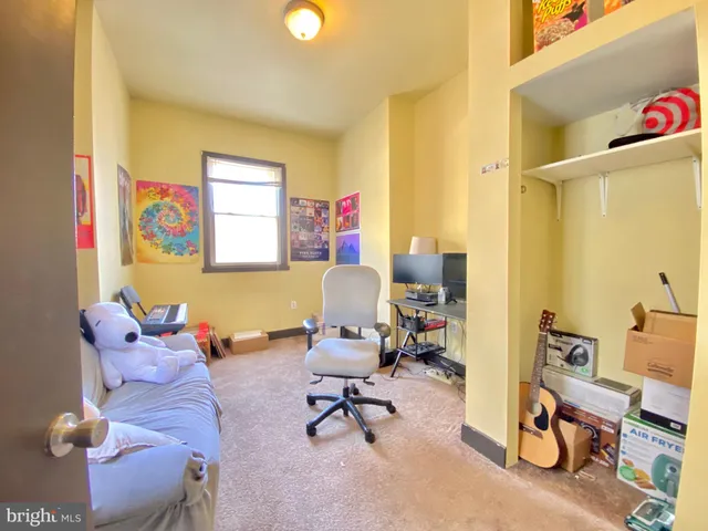 a living room with furniture and a work place area