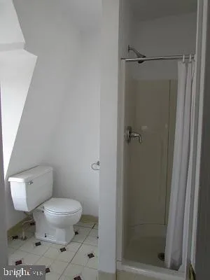 a white toilet sitting next to a bathroom sink
