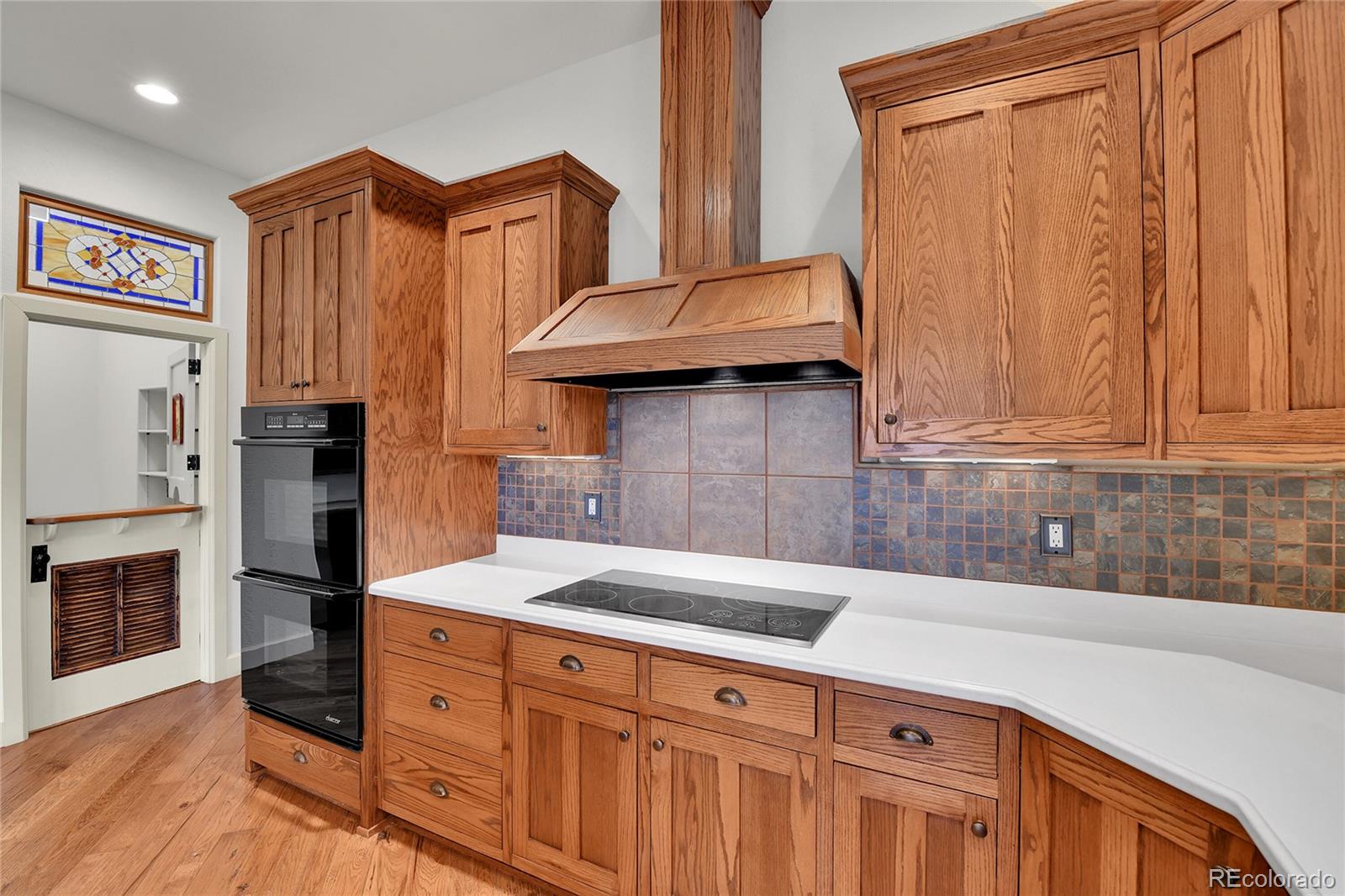 12984 Crowfoot Springs Road Franktown, CO 80116 - Photo 12 of 50 a kitchen with stainless steel appliances a refrigerator and cabinets