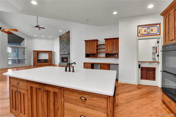 a view of kitchen with sink microwave refrigerator and cabinets