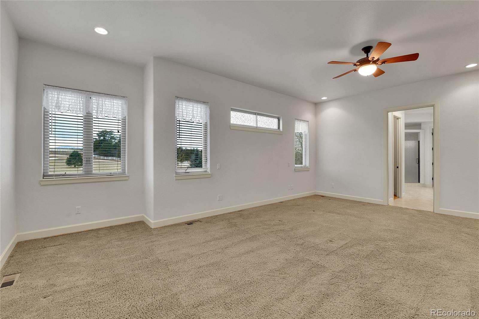 12984 Crowfoot Springs Road Franktown, CO 80116 - Photo 20 of 50 an empty room with windows and fan