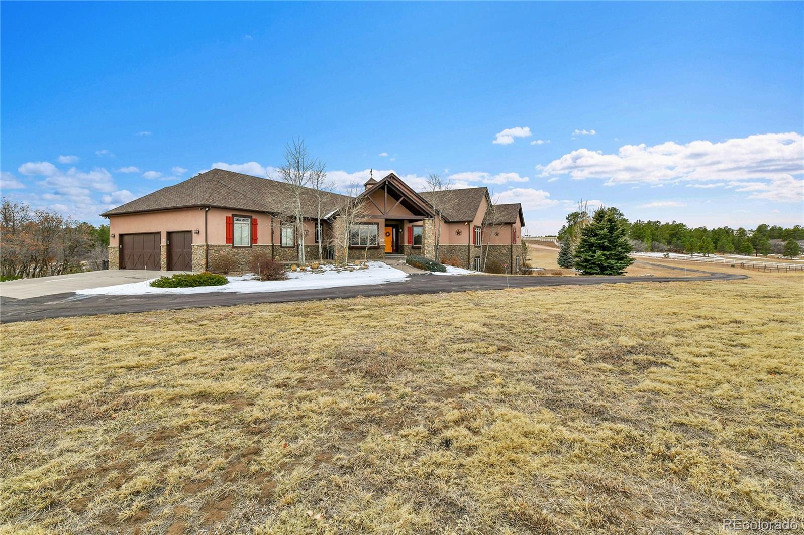 12984 Crowfoot Springs Road Franktown, CO 80116 - Photo 2 of 50 a front view of a house with a yard
