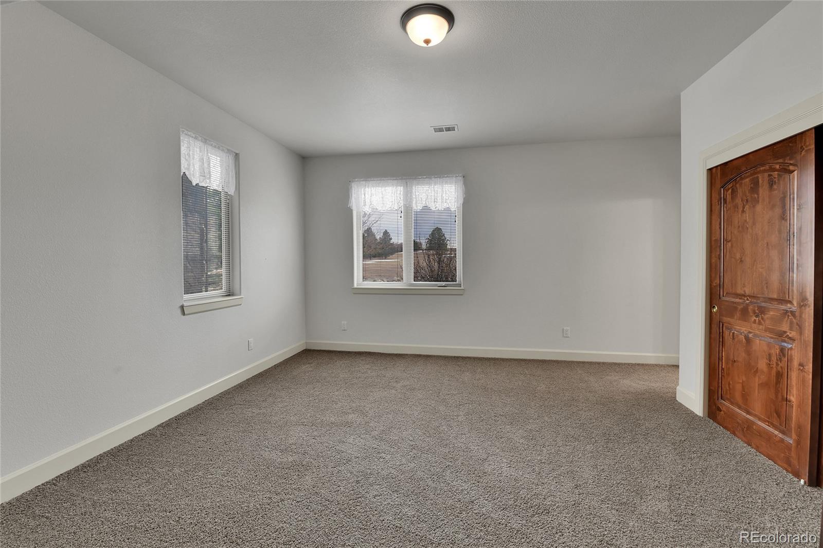 12984 Crowfoot Springs Road Franktown, CO 80116 - Photo 25 of 50 an empty room with windows and closet