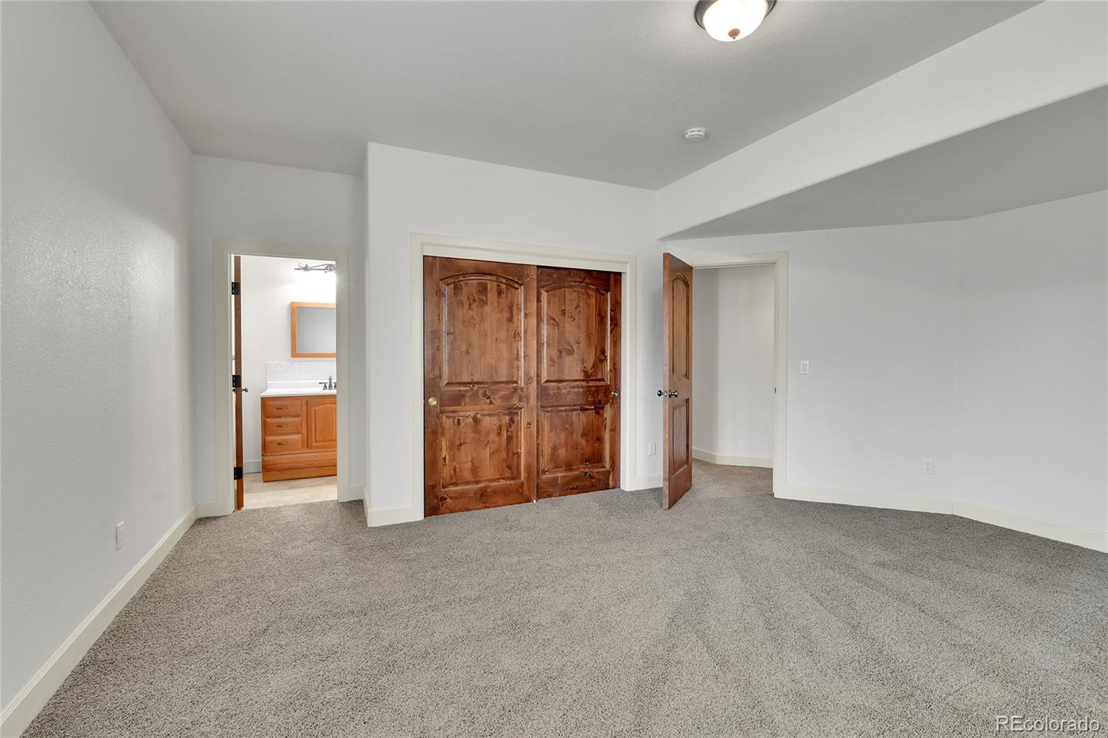 12984 Crowfoot Springs Road Franktown, CO 80116 - Photo 26 of 50 a view of empty room with wooden floor