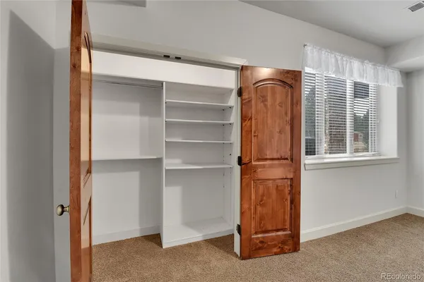 an empty room with windows and stairs